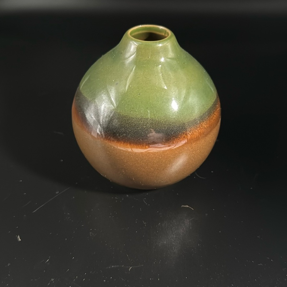 3” pottery vase no signature or markings. No chips or cracks.